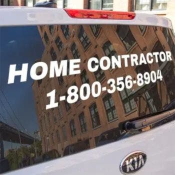 White vinyl lettering on the back window of a truck