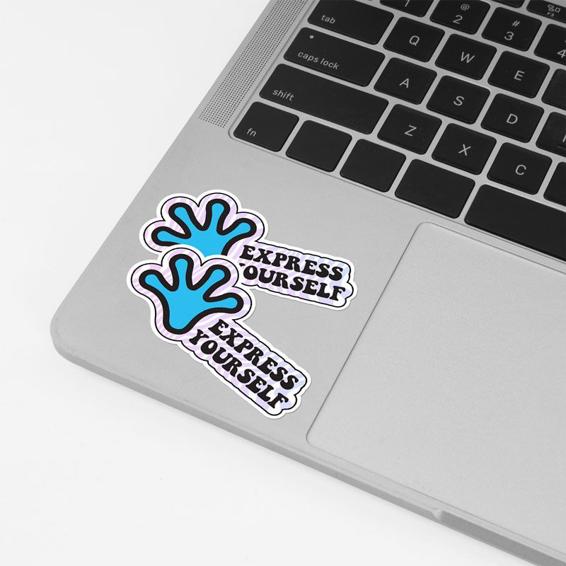 Two 'Express Yourself' stickers with a blue handprint design placed on the silver palm rest of a laptop near the trackpad.